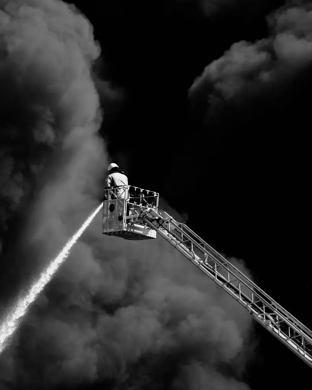 Drehleiter beim Löschangriff in dichtem Brandrauch